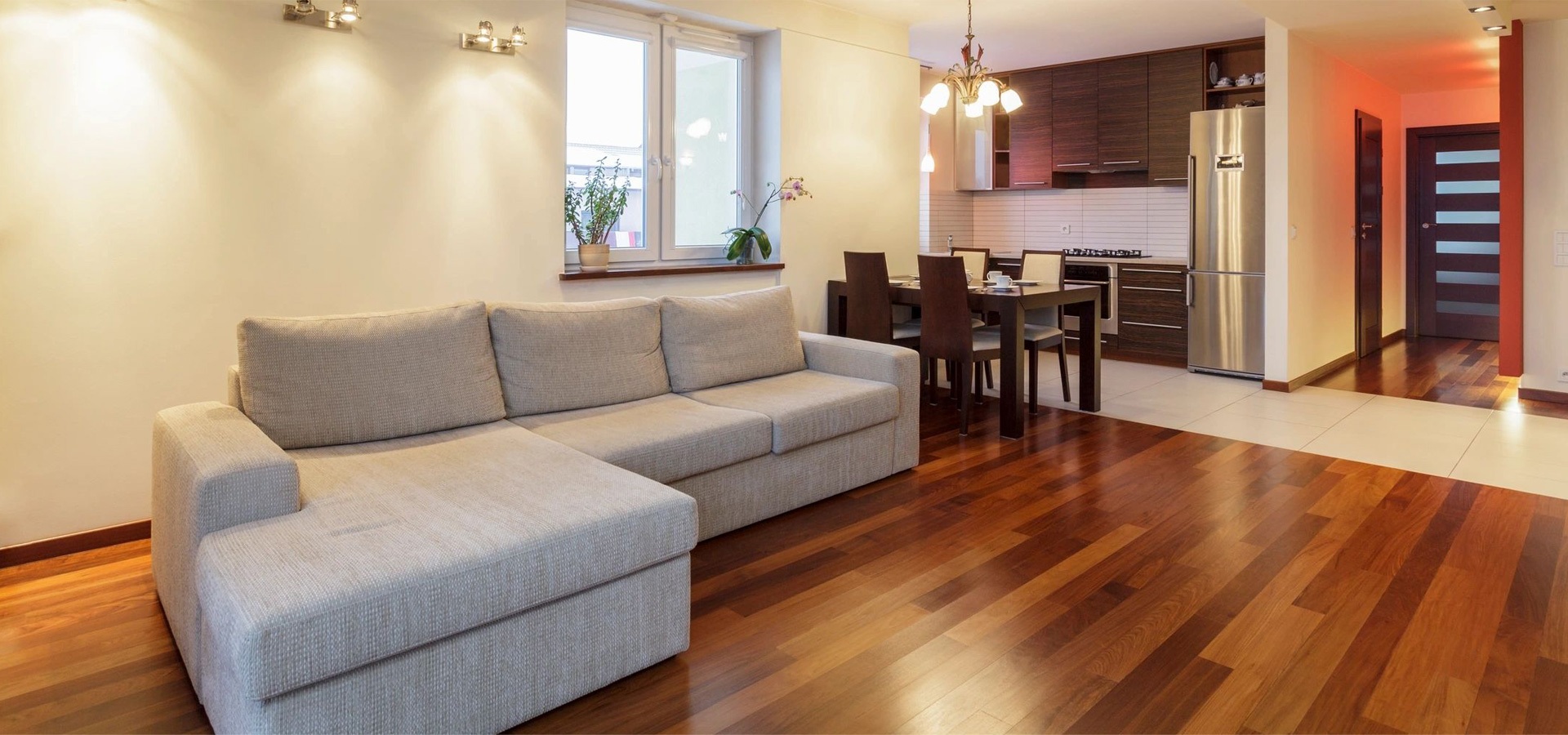 A living room with wooden floors and white walls.