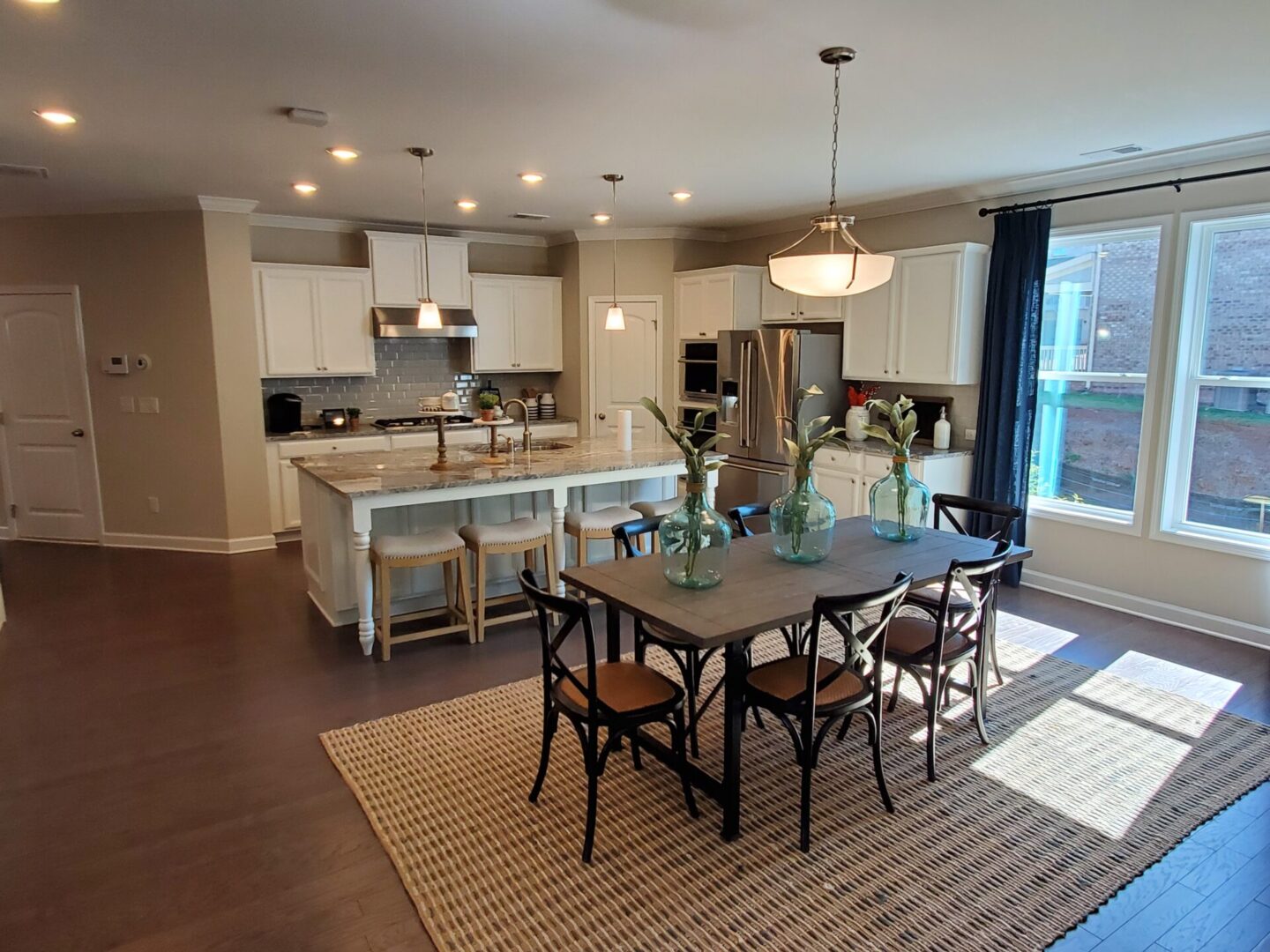 Kitchen dining area with island and rug.