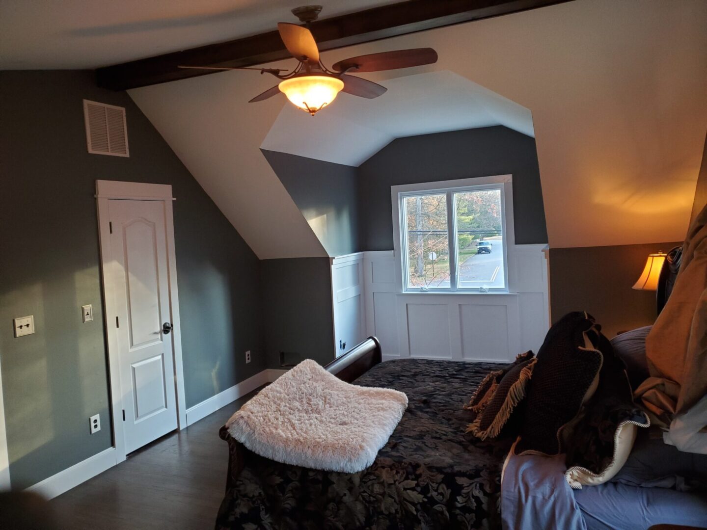 Bedroom with a bed, window, and ceiling fan.