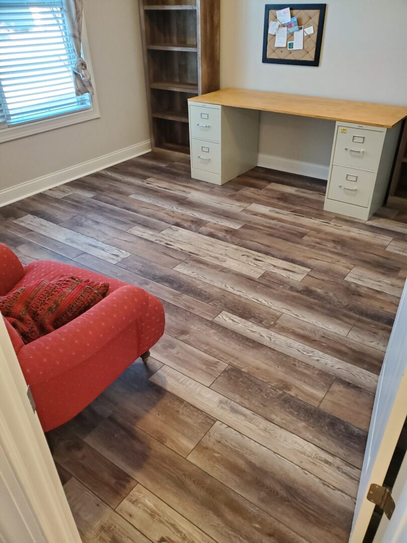 Wood floor in a home office with a desk and chair.