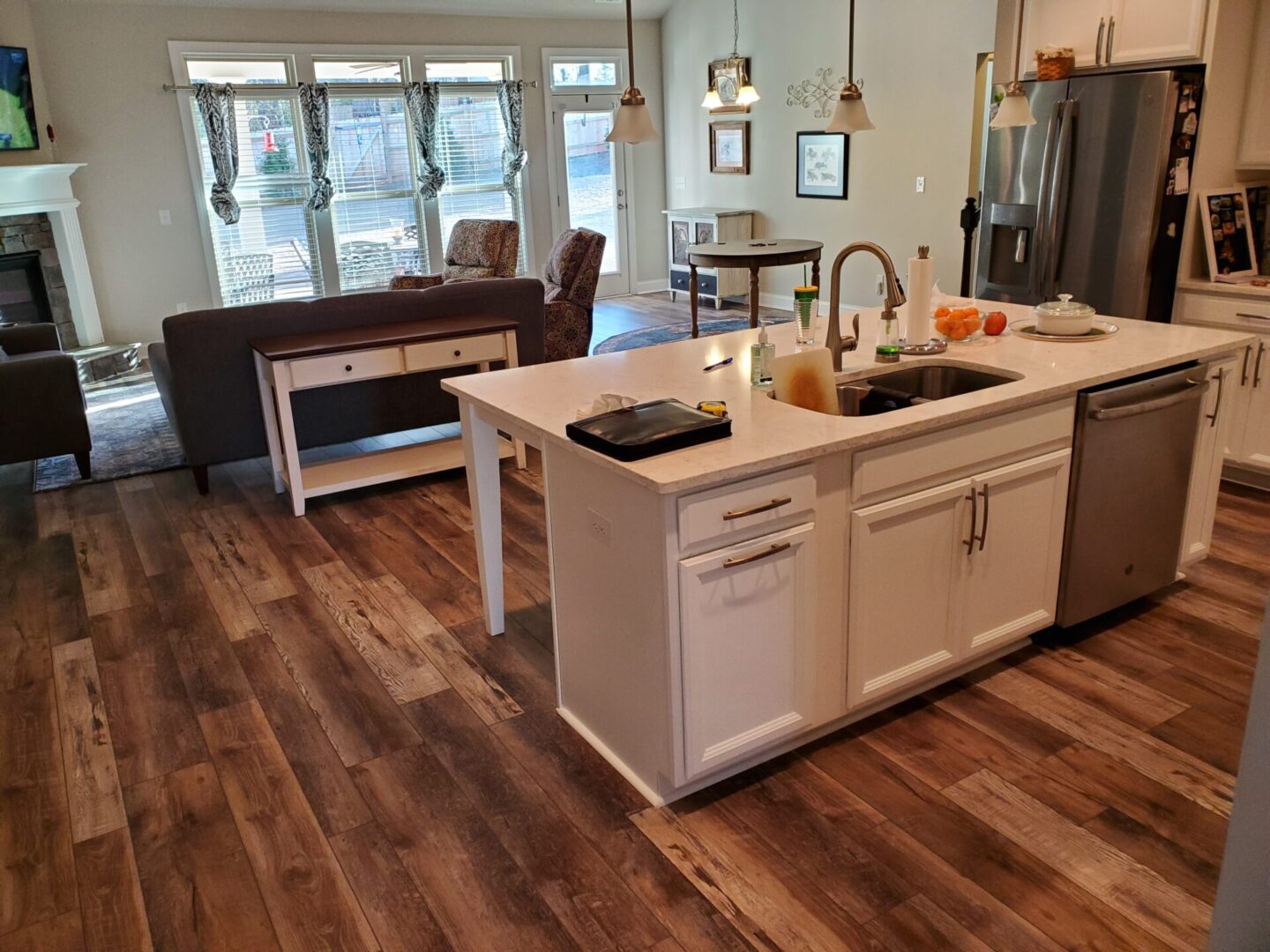 Kitchen island with white cabinets and hardwood floors.
