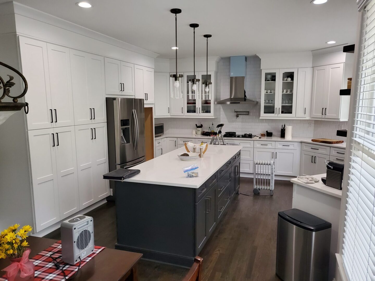 Modern kitchen with white cabinets and island.