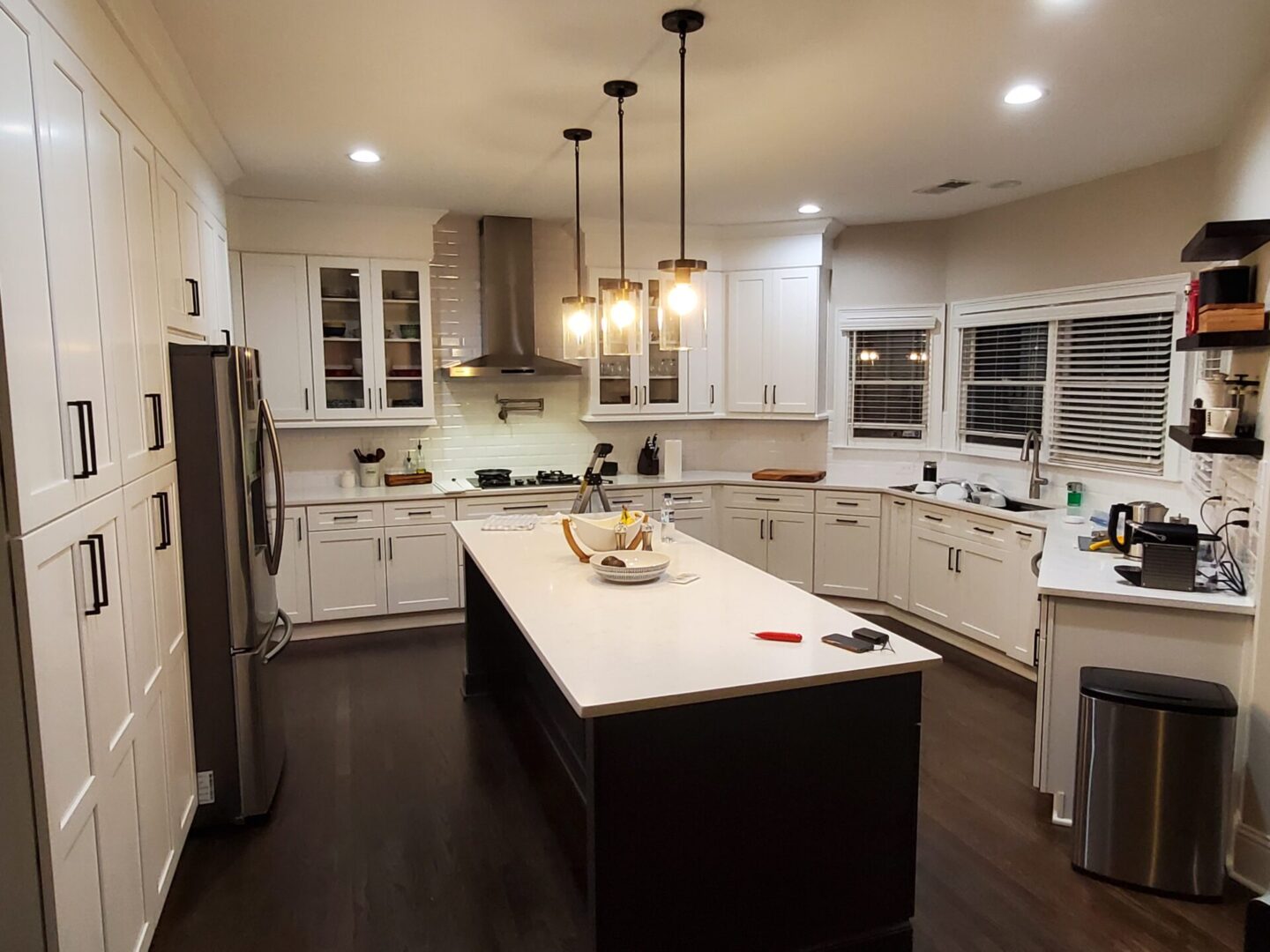 Modern kitchen with white cabinets and island.