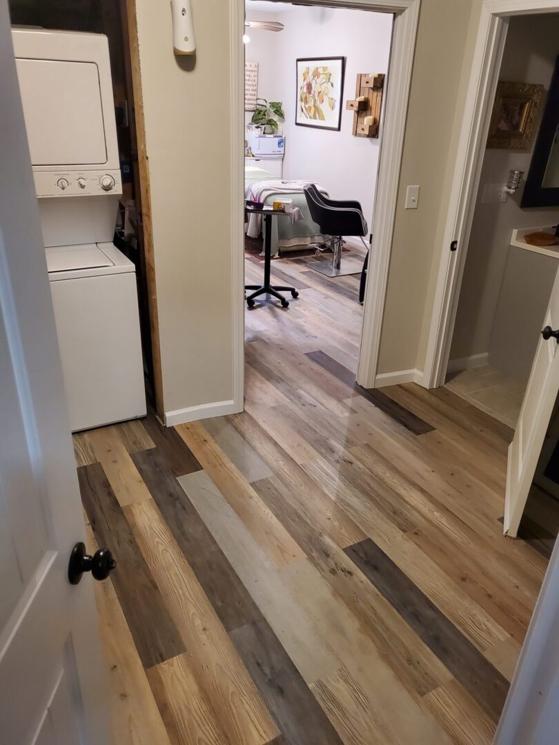 Wood-look floor in a hallway with doors open.